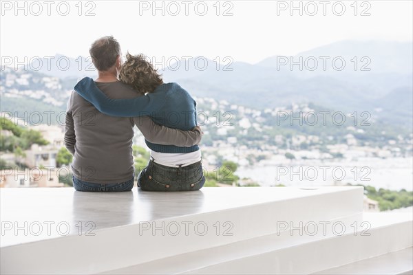 Couple admiring view from balcony