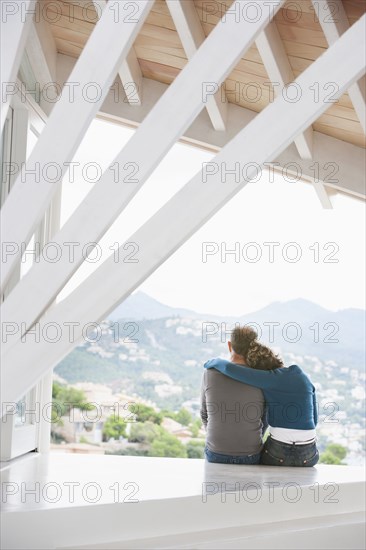 Couple admiring view from balcony