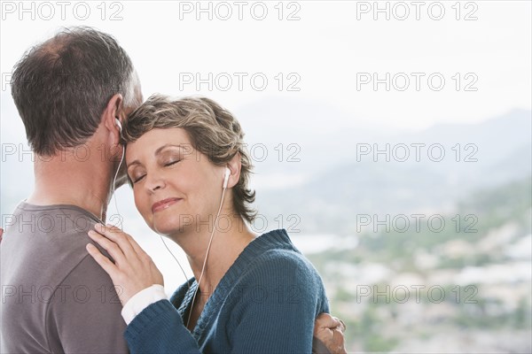 Couple listening to earphones together