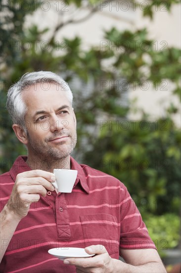 Man drinking espresso outdoors