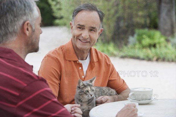 Men having coffee together outdoors