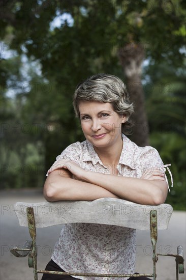 Woman sitting in chair outdoors