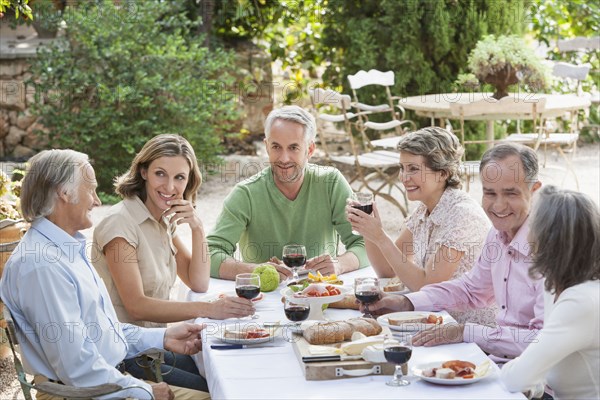 Friends eating together outdoors