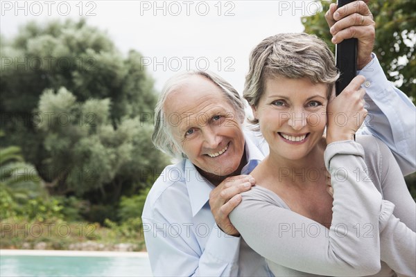 Couple standing by swimming pool