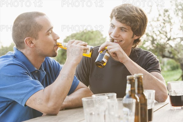 Men drinking beer together outdoors