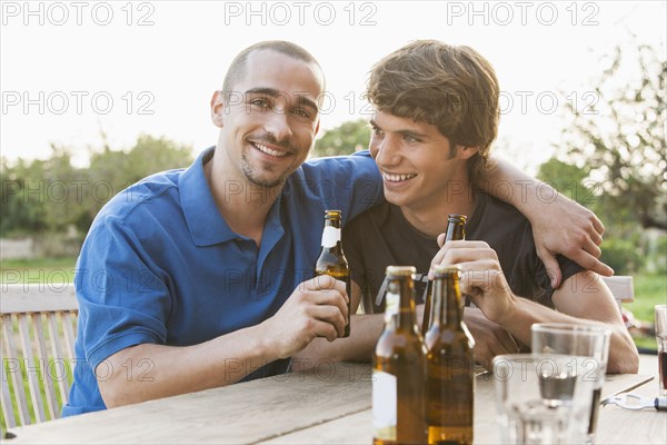 Men drinking beer together outdoors