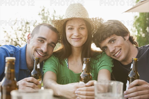 Friends drinking beer together outdoors