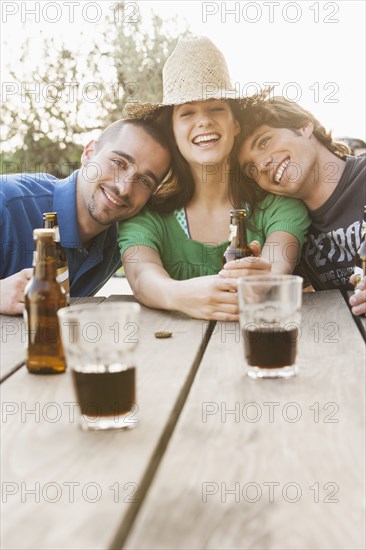 Friends drinking beer together outdoors