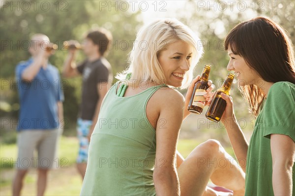 Women drinking beer outdoors