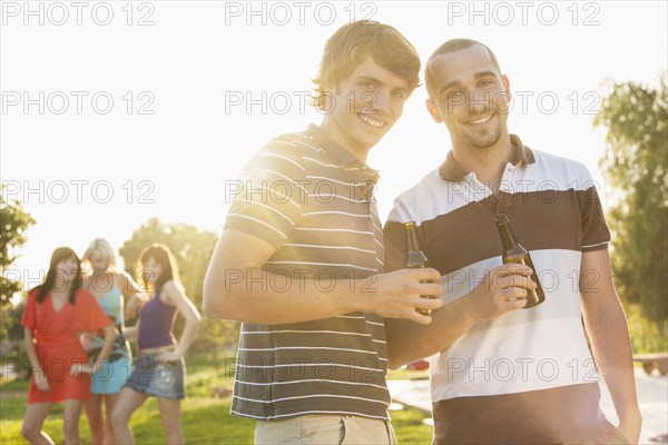 Men drinking beer together at party