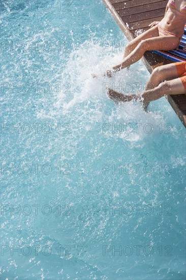 Couple splashing in swimming pool