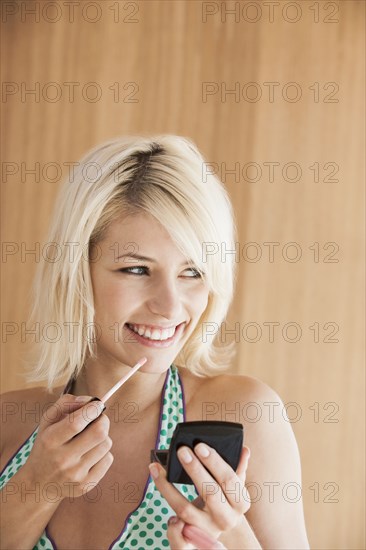 Woman putting on makeup