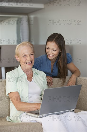 Caucasian mother and daughter using laptop