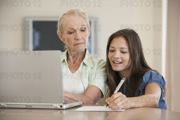 Caucasian mother and daughter using laptop