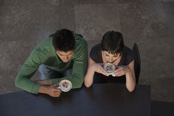 Caucasian couple drinking coffee together