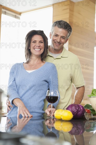 Hispanic couple cooking in kitchen