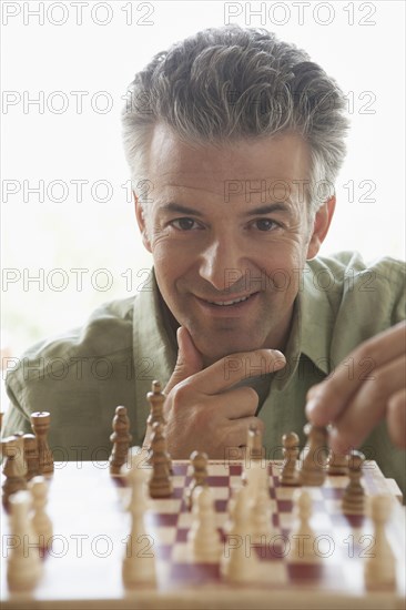 Hispanic man playing chess