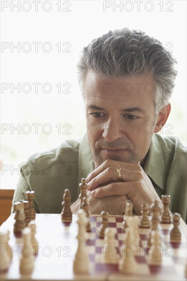 Hispanic man playing chess