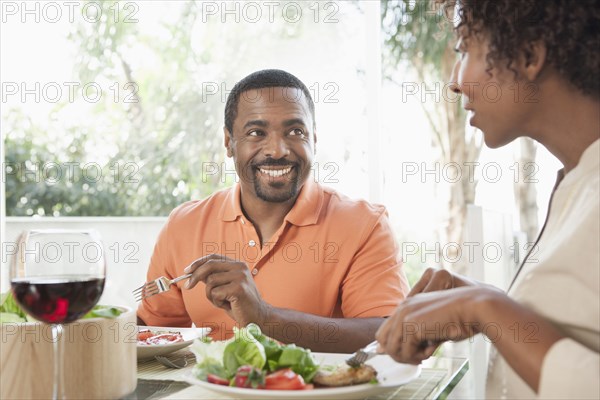 African American couple eating together