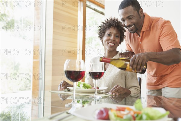 African American couple having wine at dinner