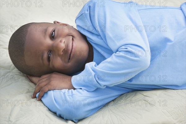 African American boy smiling on picnic blanket