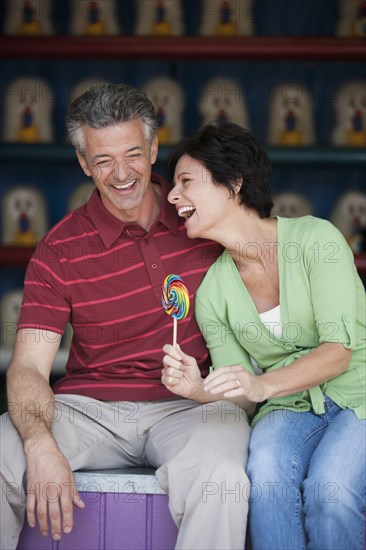 Caucasian couple relaxing at theme park