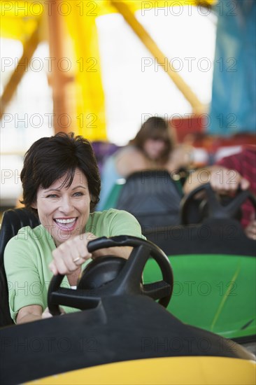 Caucasian woman driving bumper car