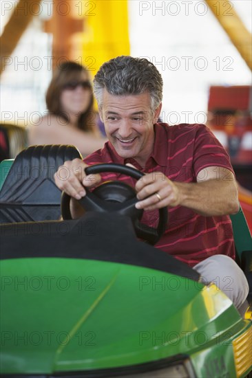 Caucasian man driving bumper car
