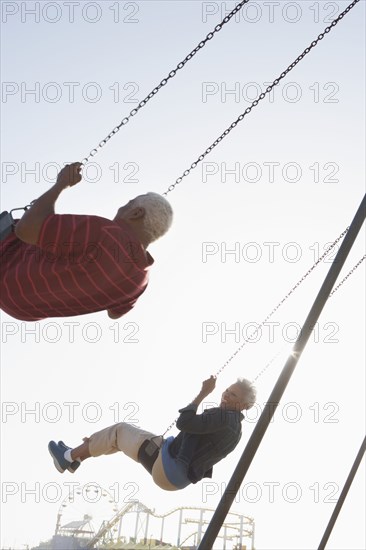 Senior African American couple on swing set