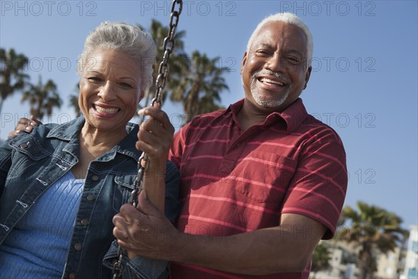 Senior African American couple on swing set