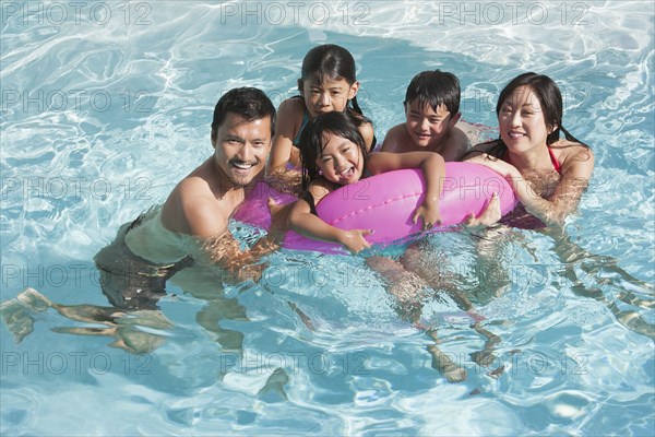 Family playing together in swimming pool