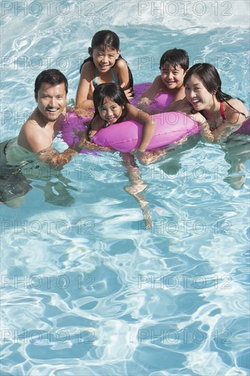 Family playing together in swimming pool