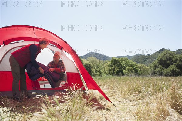 Senior Caucasian couple packing up campsite