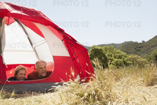 Senior Caucasian couple relaxing in tent