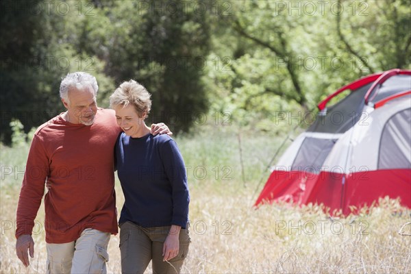 Senior Caucasian couple walking in rural field