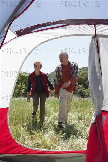 Senior Caucasian couple walking to campsite