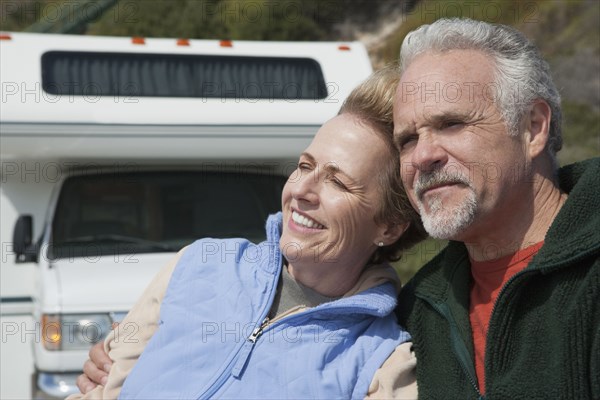 Caucasian couple relaxing by RV