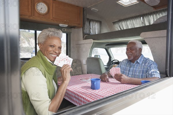 Mixed race Senior couple playing cards in RV