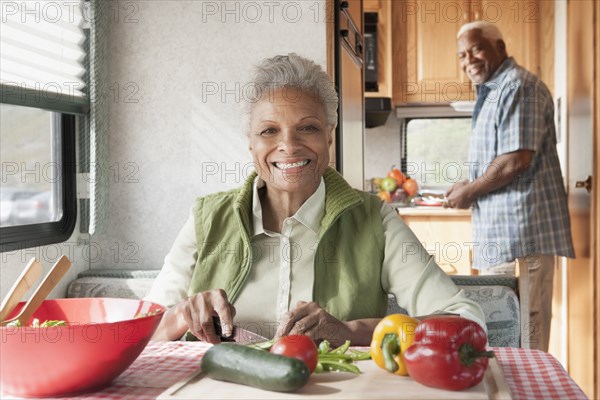 Mixed race Senior couple cooking in RV