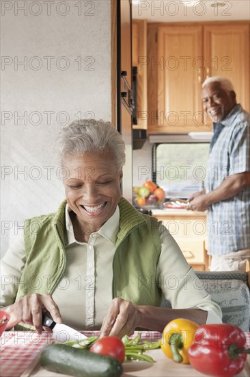 Mixed race Senior couple cooking in RV