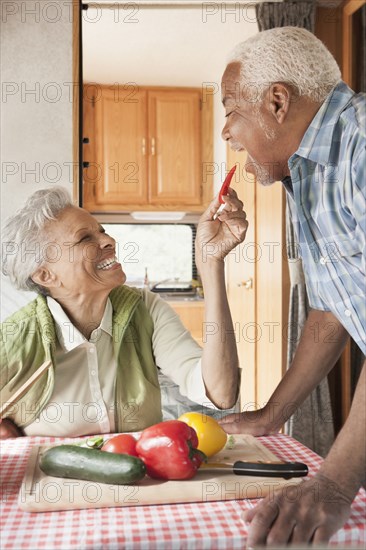 Mixed race Senior couple cooking in RV