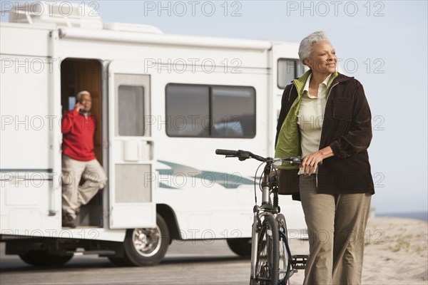 Mixed race Senior woman with bicycle outdoors