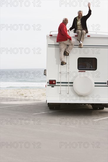 Mixed race Senior couple sitting on RV