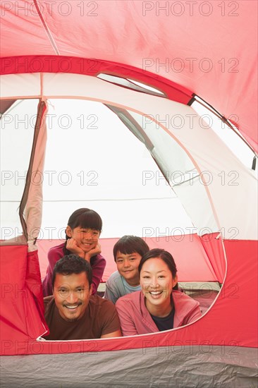 Family relaxing together in tent