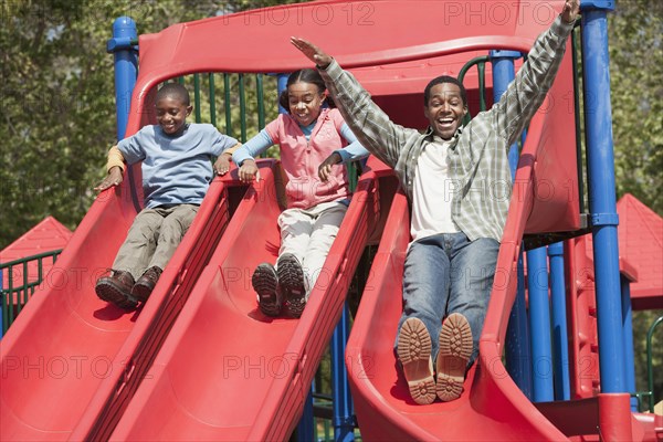 Father and children playing together at playground