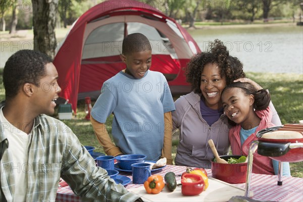 Family cooking together at campsite