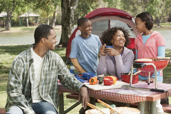 Family cooking together at campsite