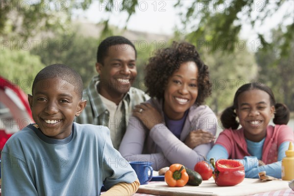 Family smiling together at campsite