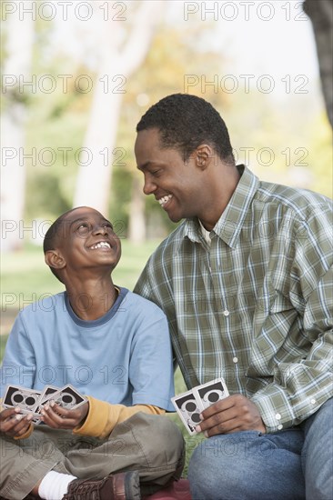 Father and son playing cards at campsite