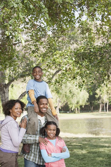 Family smiling together in park